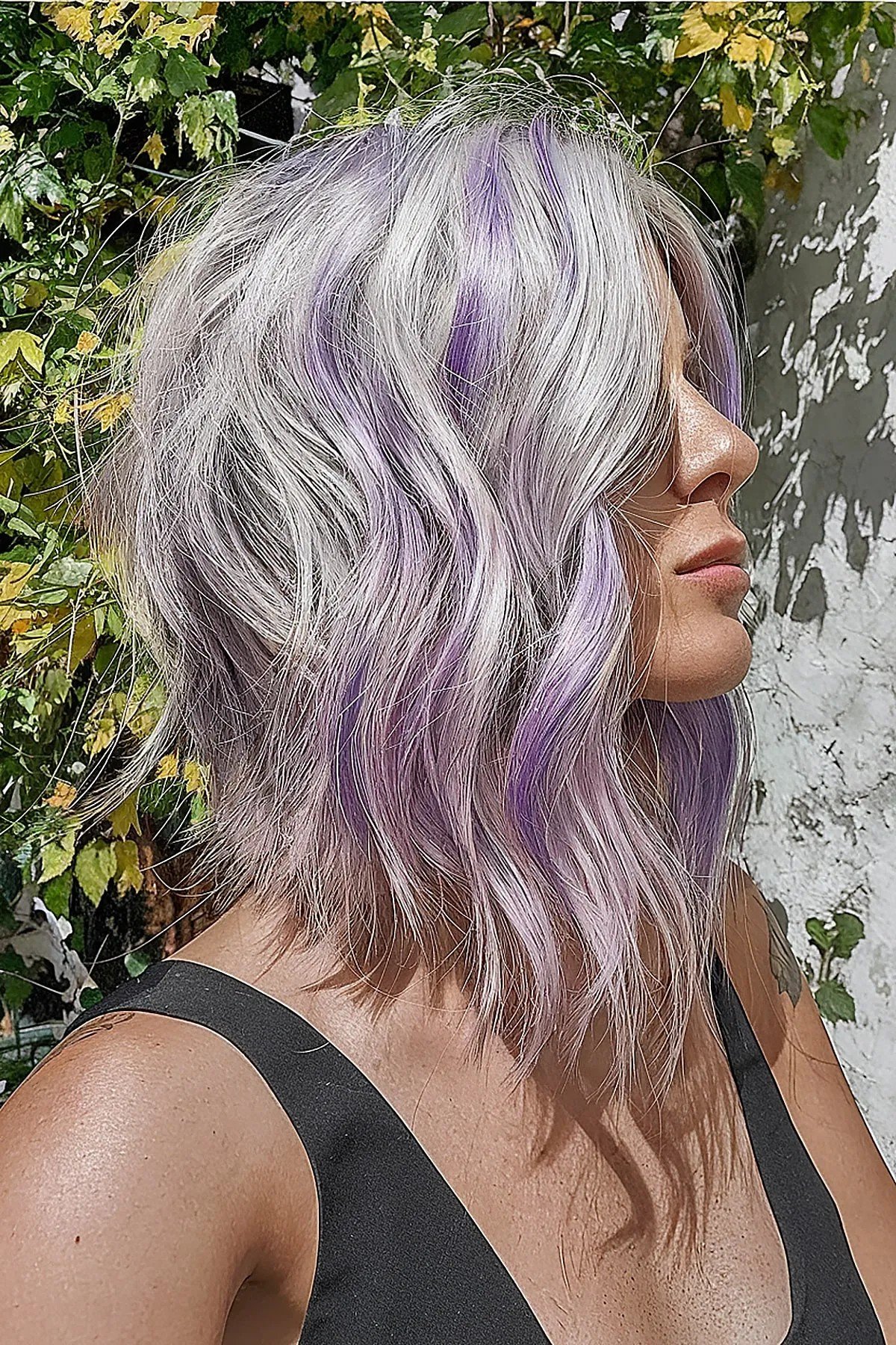 Choppy Collarbone-length Angled Wavy Bob With Purple Highlights on Silver Hair