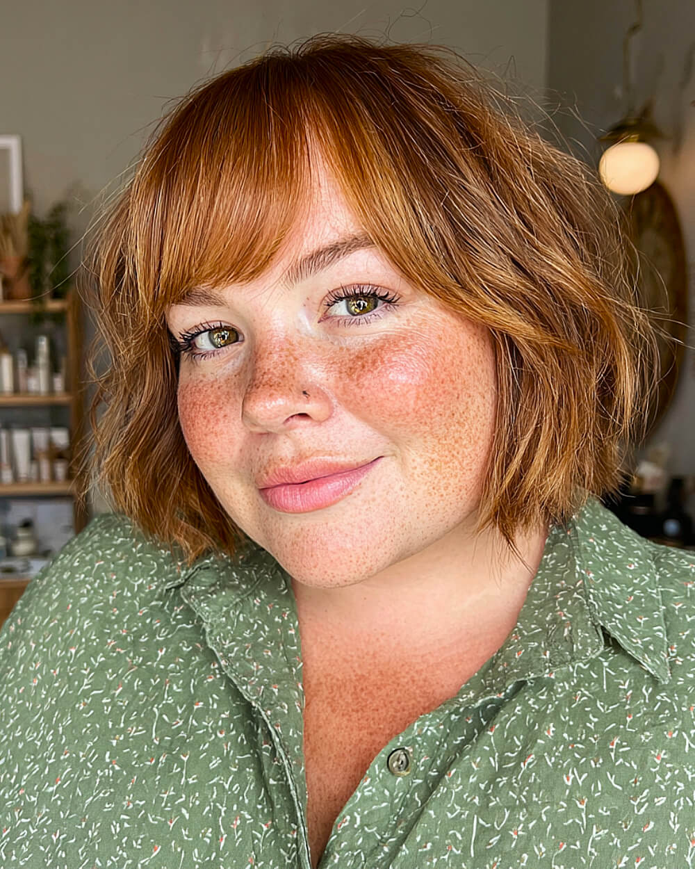Ginger-toned bob with wispy bangs and light texture