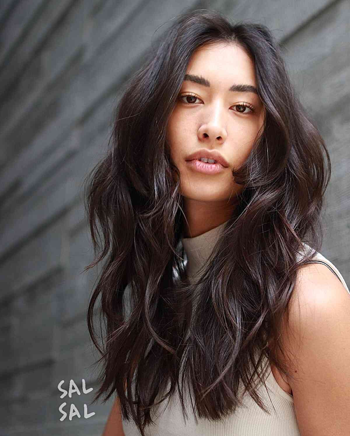 Iconic Layered Shag for Long, Fine Hair for women with a middle part and wavy tresses