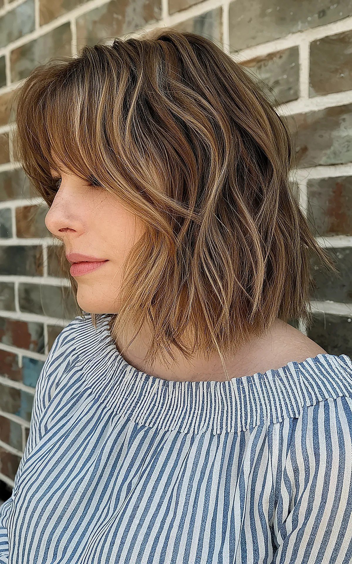Long Brunette Bobbed Hair with Subtle Choppy Layers and Bottleneck Bangs