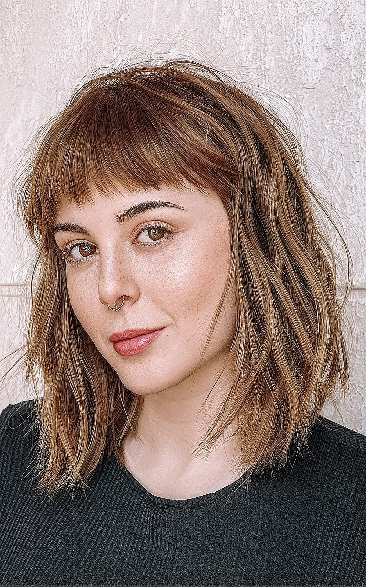 Medium-length choppy bob with soft textured bangs for fine hair