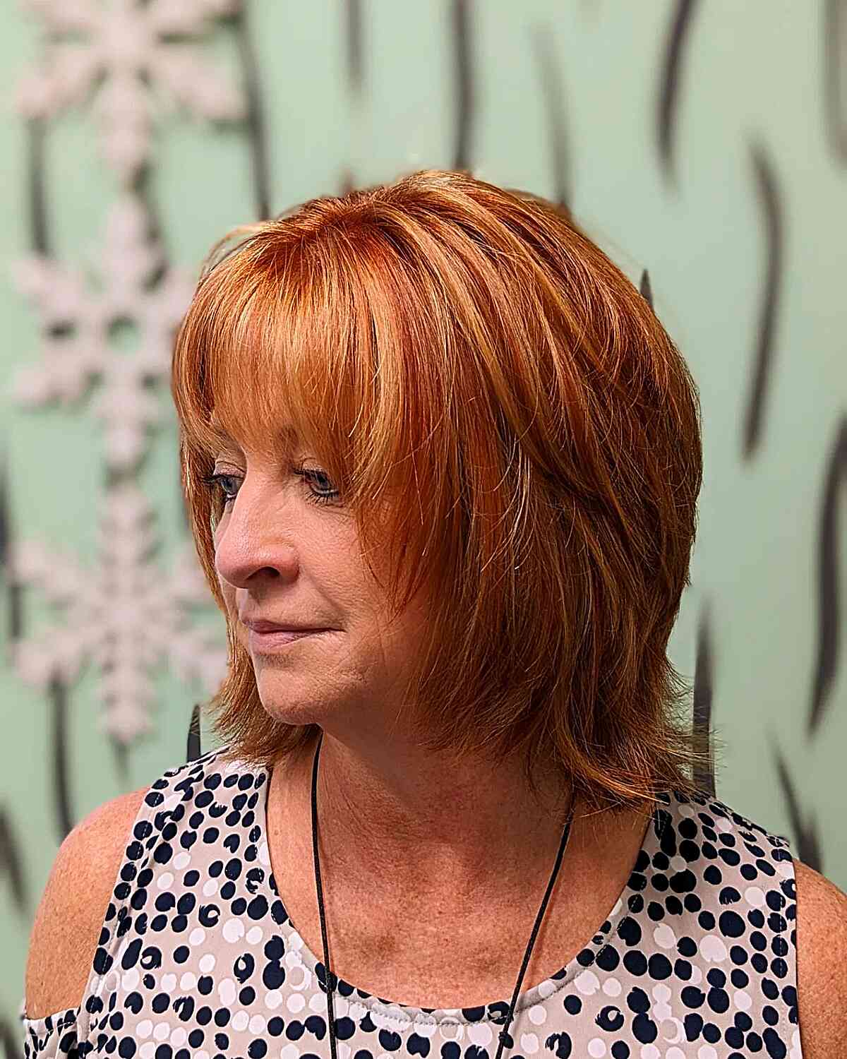 Red Layered Shaggy Bob with Blonde Highlights and Bangs for older women with short hair