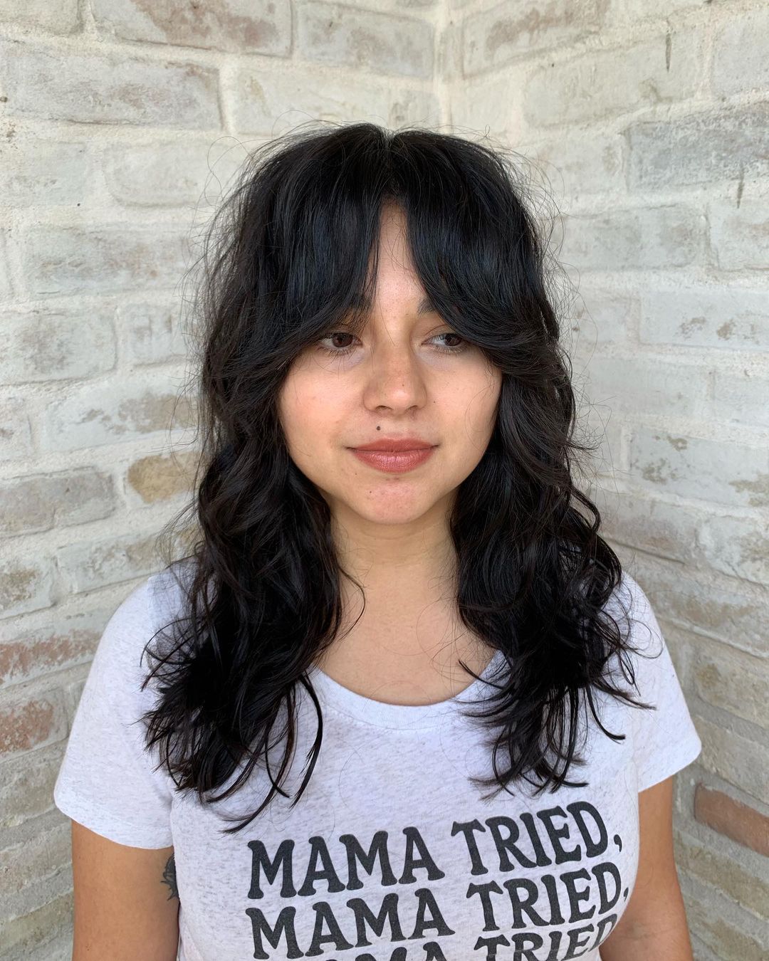 Trendy jet black shaggy layers with curtain bangs